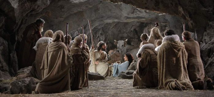 Shepherds gather around the baby Jesus